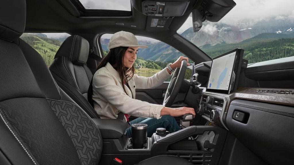 Smiling woman sitting inside her new 2025 Toyota Tacoma