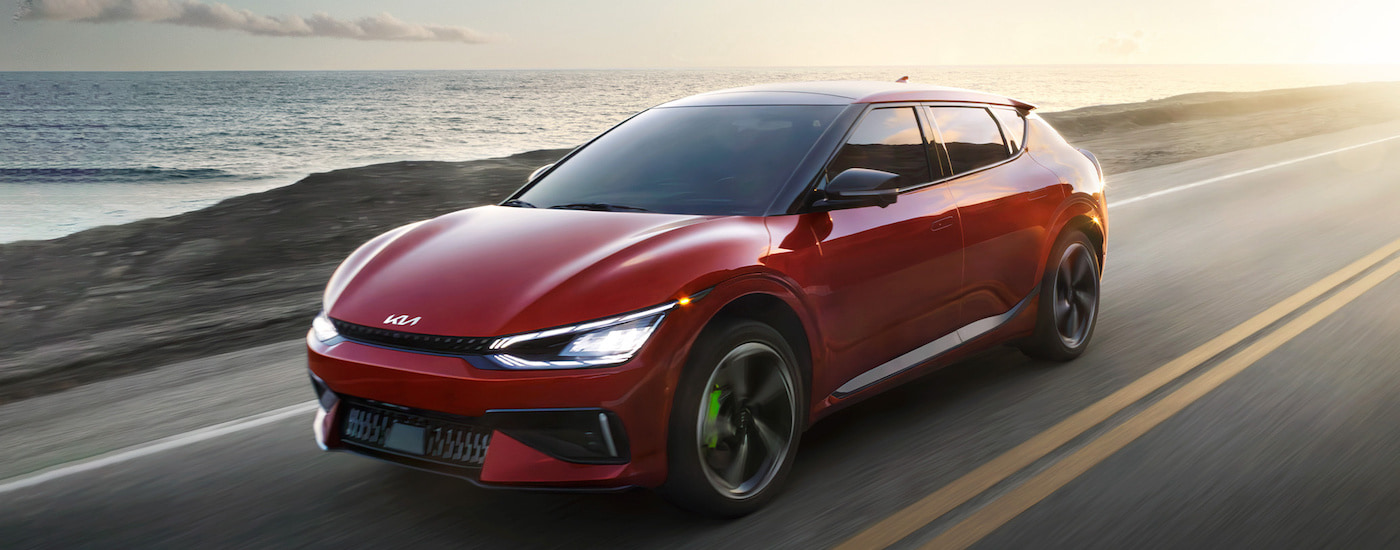 A red 2025 Kia EV6 is shown from the front at an angle.