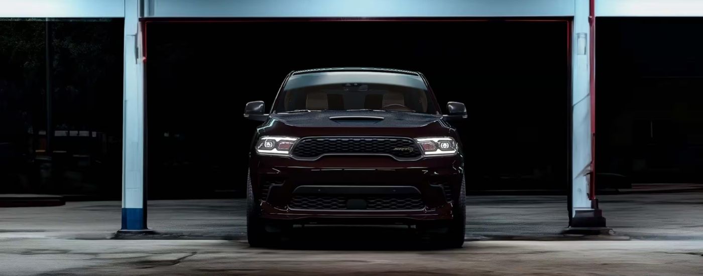 A red 2025 Dodge Durango SRT Hellcat parked underneath an overhang.