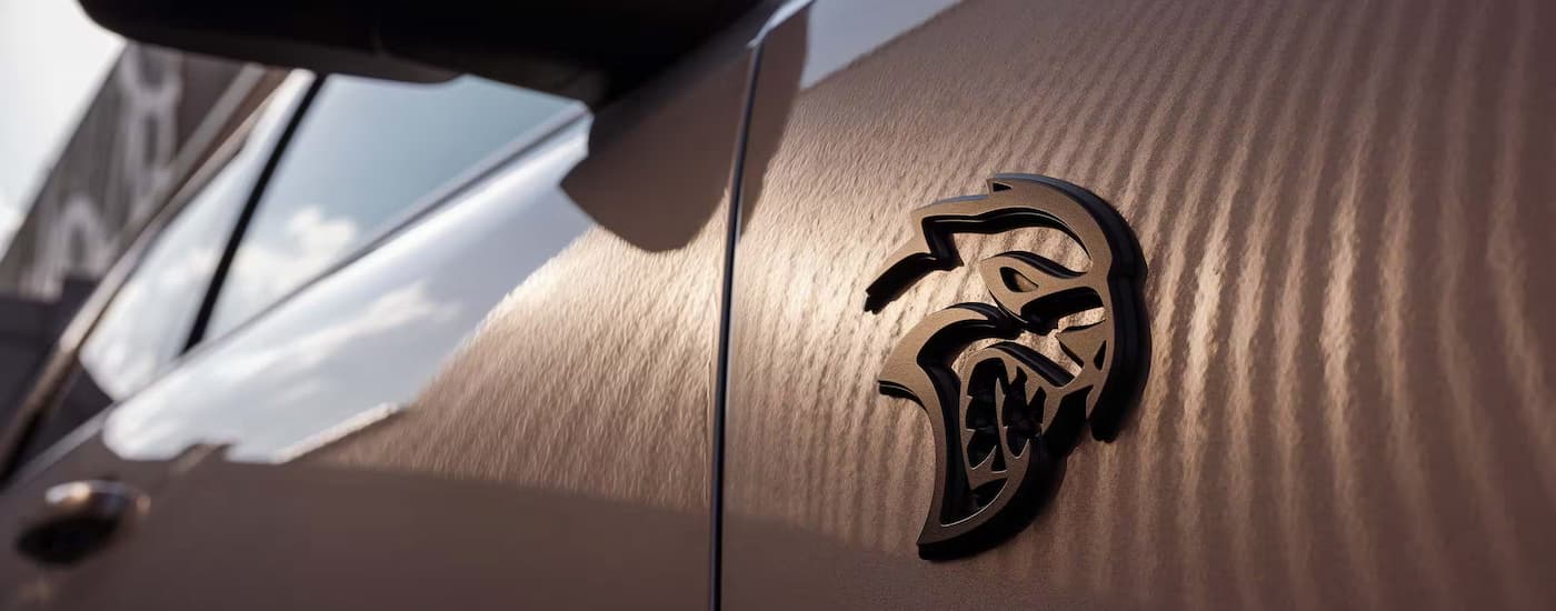 A close up of the badge on a 2025 Dodge Durango SRT Hellcat at a Dodge dealer.