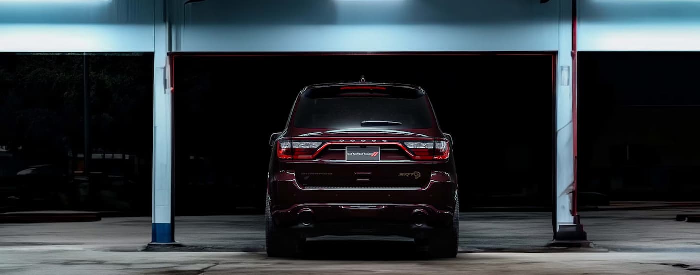 A rear view of a red 2025 Dodge Durango SRT Hellcat at night.