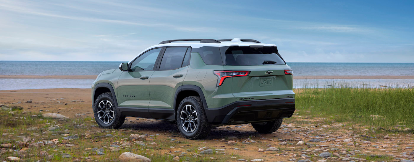 A green 2025 Chevy Equinox ACTIV is shown from the rear at an angle.