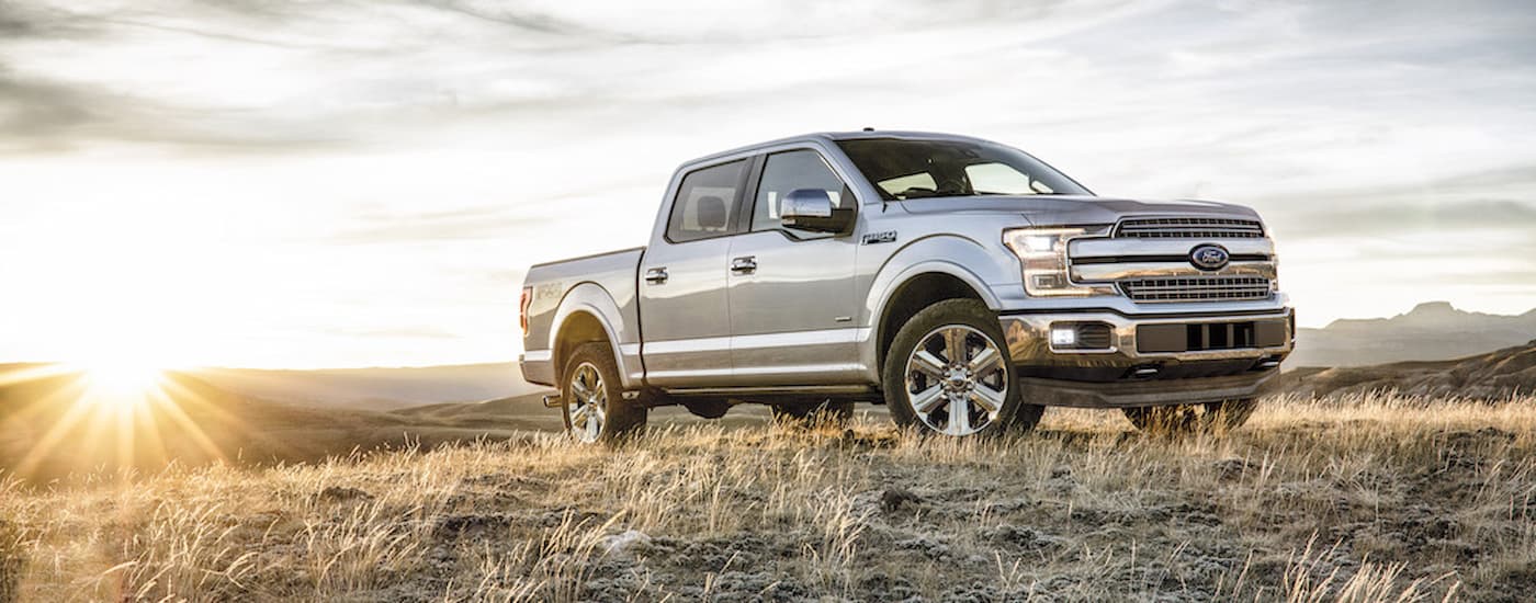 A silver 2018 Ford F-150 is shown from the side.