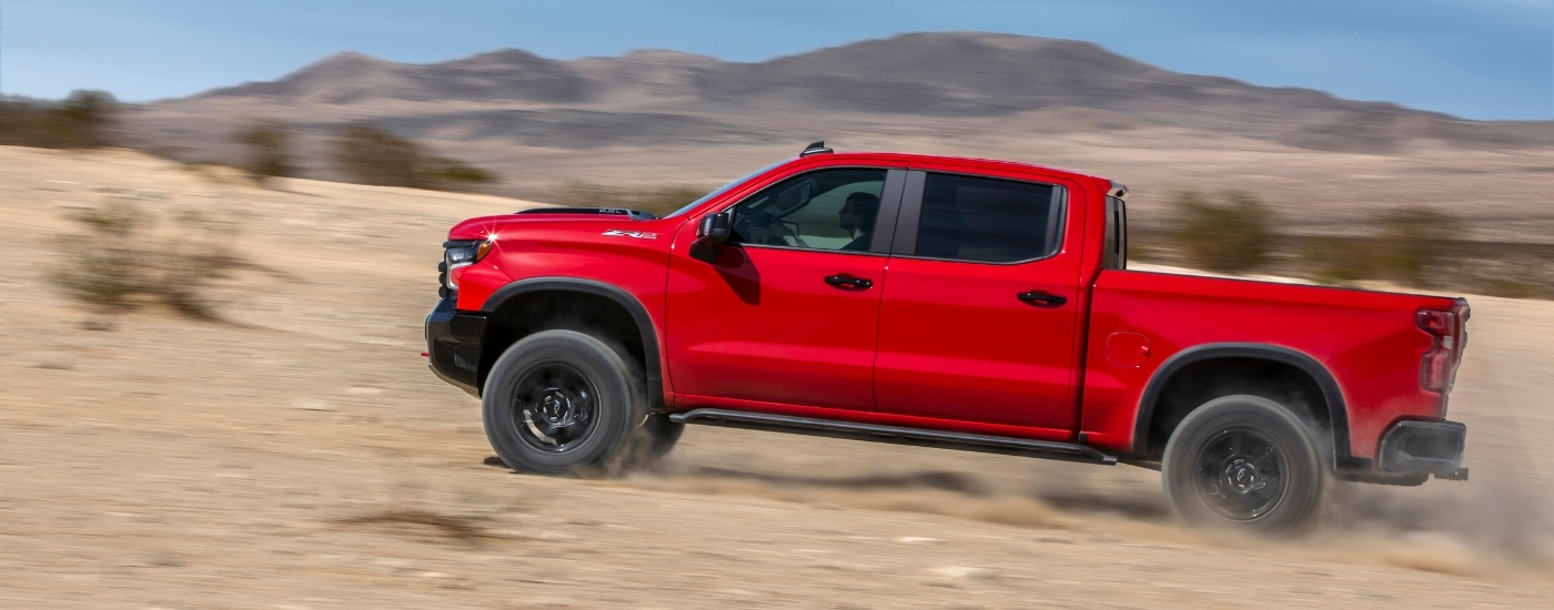 A red 2023 Chevy Silverado 1500 ZR2 is shown from the side after leaving used trucks for sale near Ignacio.