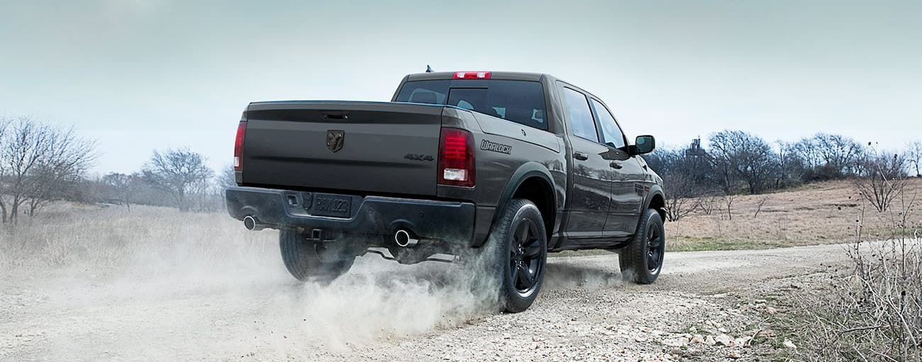 A dark grey 2025 Ram 1500 Classic Warlock for sale near Katy on a test drive.