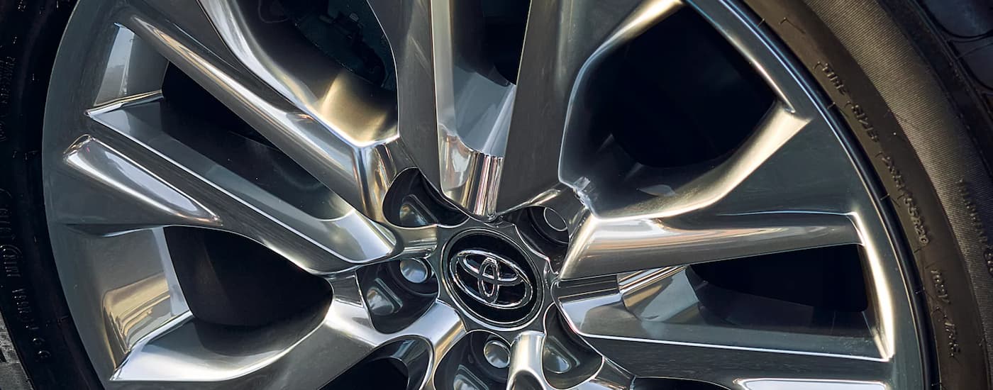 A close up of the silver rim on a 2025 Toyota Highlander.
