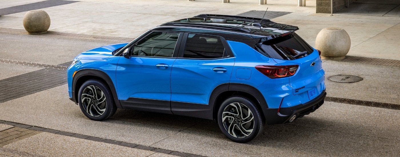 Side view of a blue 2024 Chevy Trailblazer RS parked near a Chevy dealer near Houston.