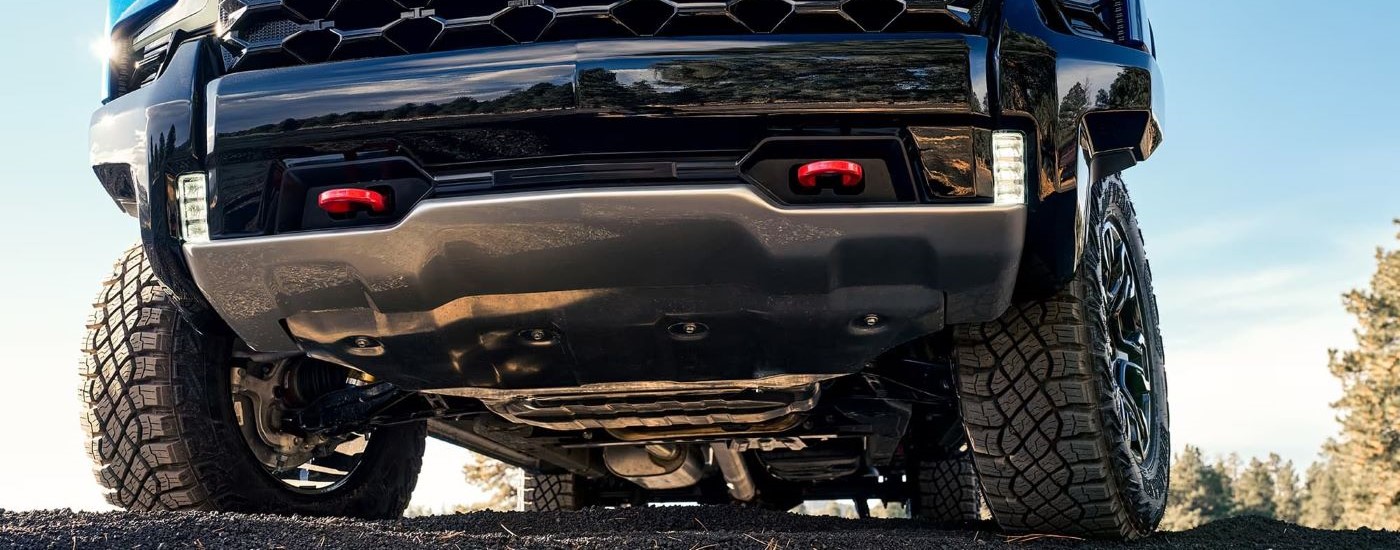 Close-up on the front wheels and bumper of a blue 2024 Chevy Silverado 1500 ZR2.