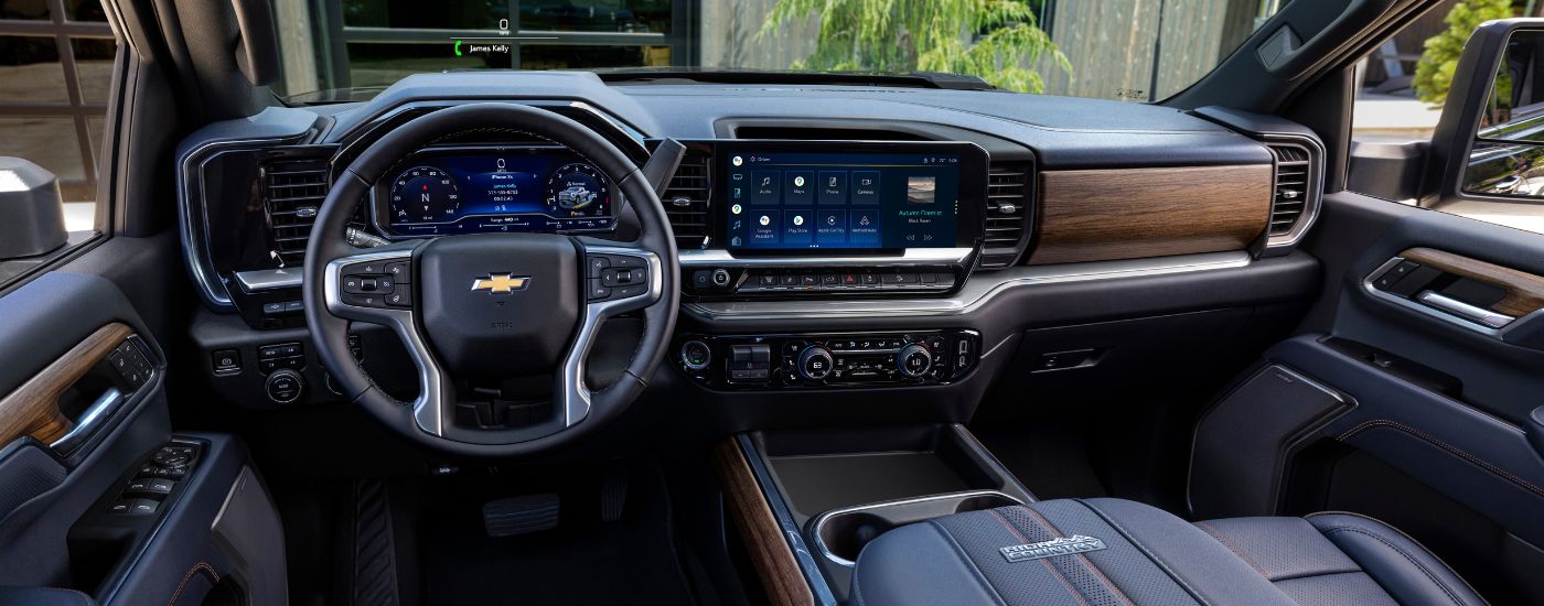 The dashboard and infotainment screens in a 2024 Chevy Silverado 2500 for sale.
