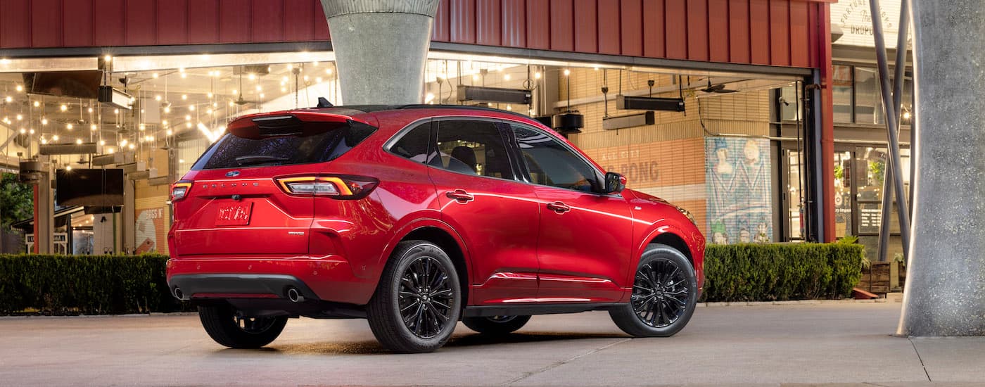 A red 2023 Ford Escape ST Line is shown from the rear at an angle after leaving a dealer that has used Ford for sale.