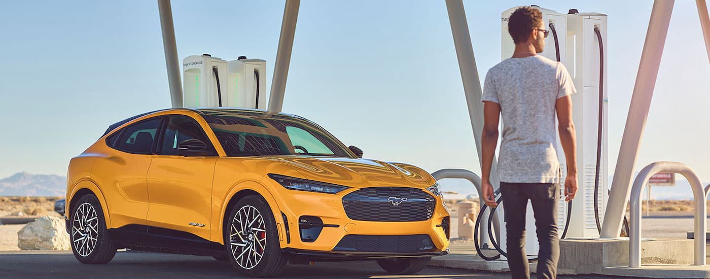 A yellow 2022 Ford Mustang Mach-E GT is shown from the front at an angle.