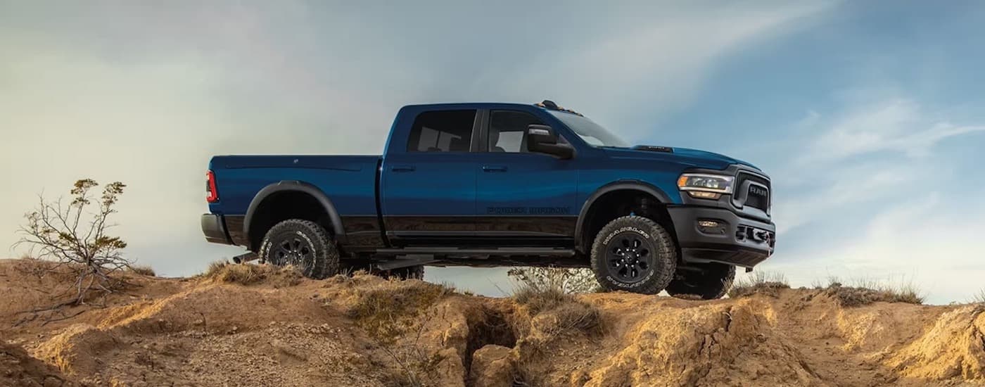 A blue 2025 Ram 2500 Power Wagon parked near a cliff.