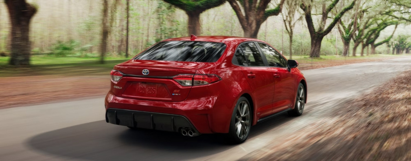 A red 2023 Toyota Corolla SE is shown from the rear at an angle.