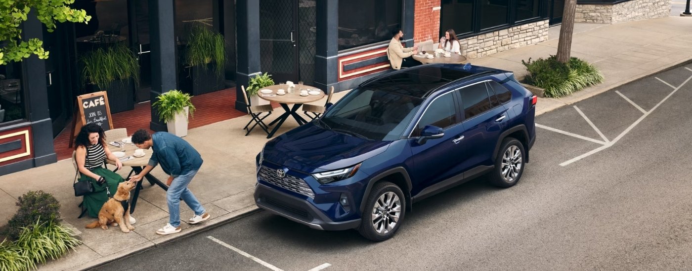 A blue 2025 Toyota RAV4 Hybrid for sale is shown from the front at an angle.