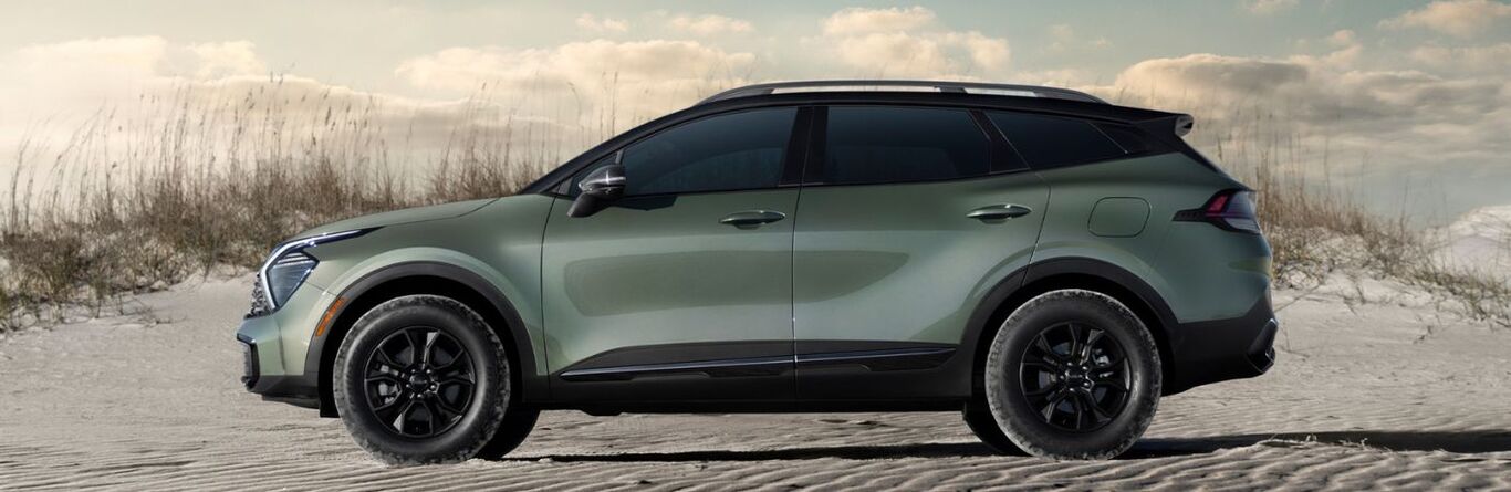 2025 Kia Sportage side view parked on a beach