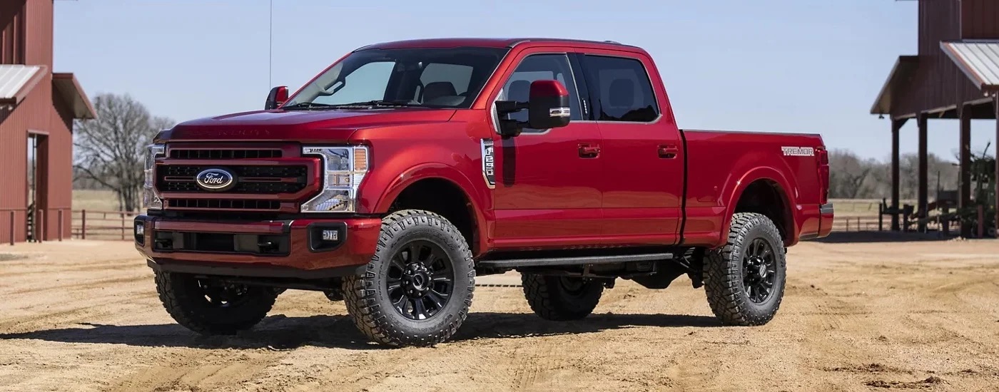 A red 2022 Ford F-250 Tremor is shown from the side.