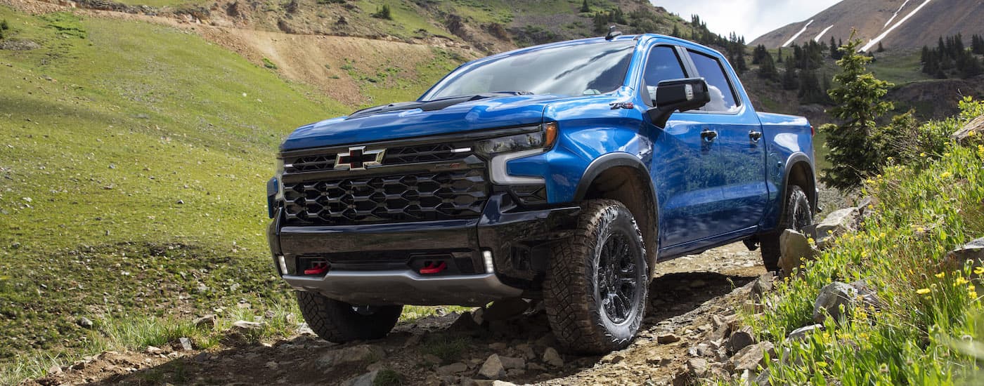 A blue 2025 Chevy Silverado 1500 ZR2 is shown from the front at an angle.