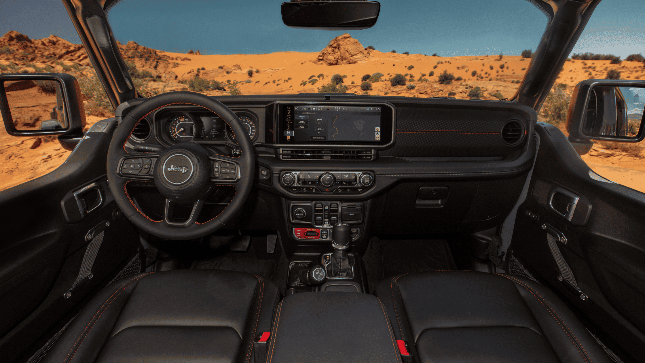 Interior view of the 2025 Jeep&reg; Wrangler featuring a digital instrument cluster, Uconnect&reg; display, and off-road controls.