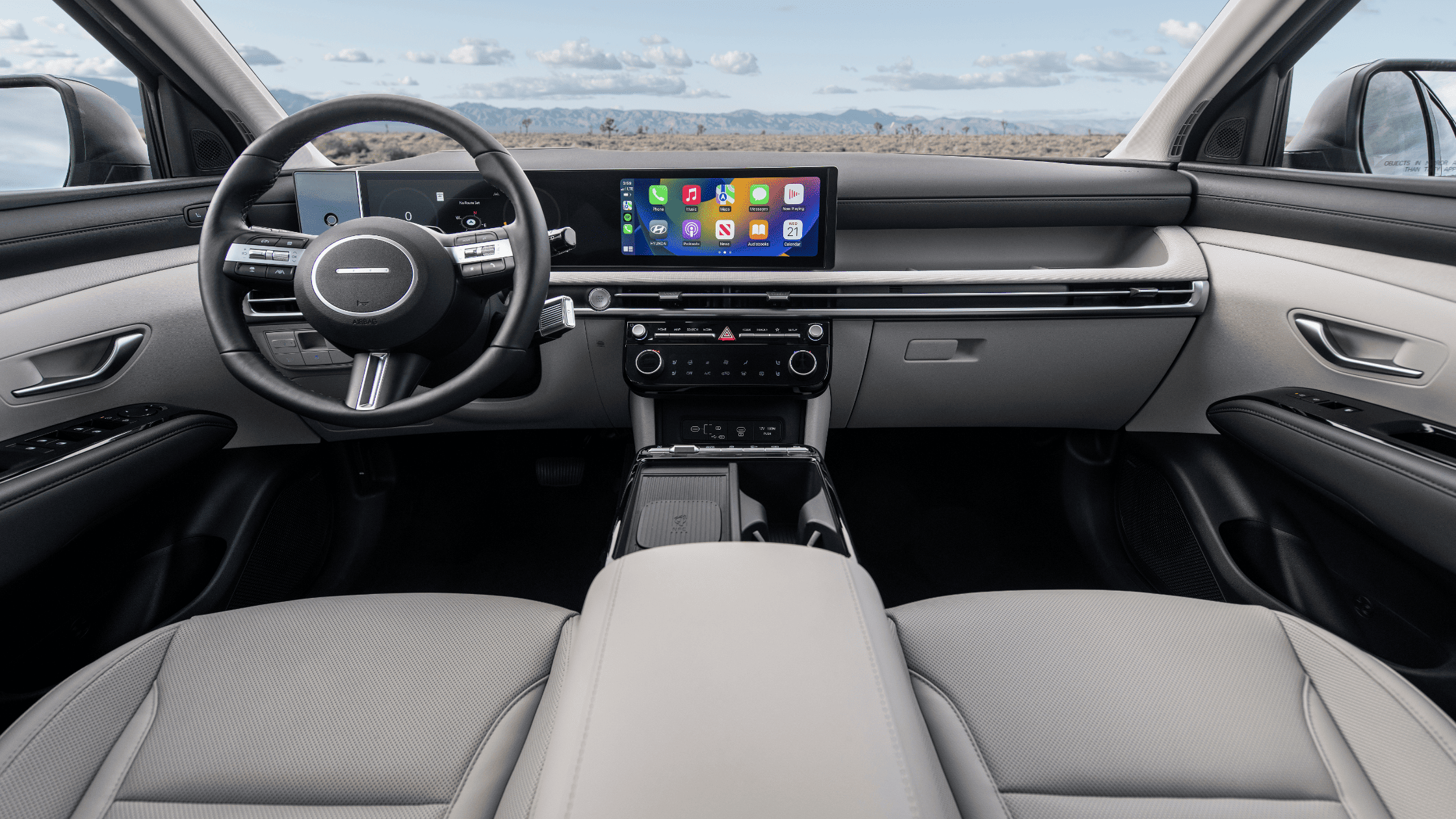 Interior dashboard of the 2025 Hyundai Tucson with touchscreen and dual-tone styling.