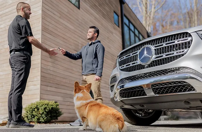 Man with dog handing over keys to a Mercedes-benz of lehigh valley technician