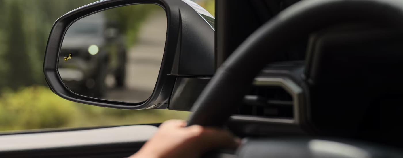 Blind spot monitor in a 2025 Toyota Tacoma at a Toyota dealer near Canyon Lake.