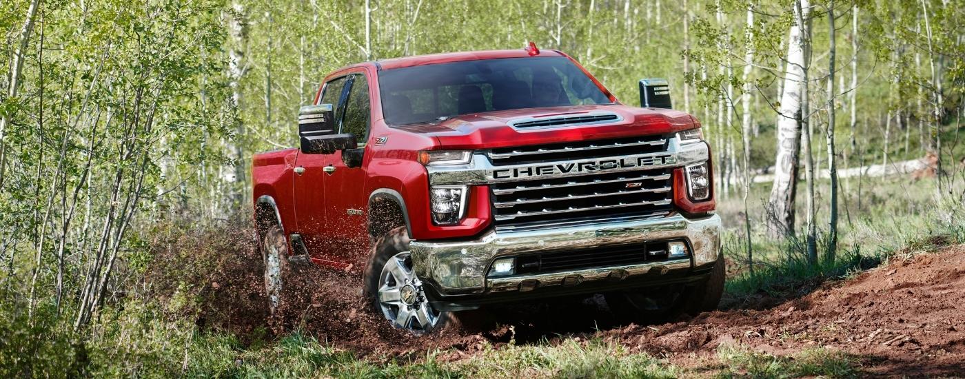 A red 2022 Chevy Silverado 2500 off-roading.