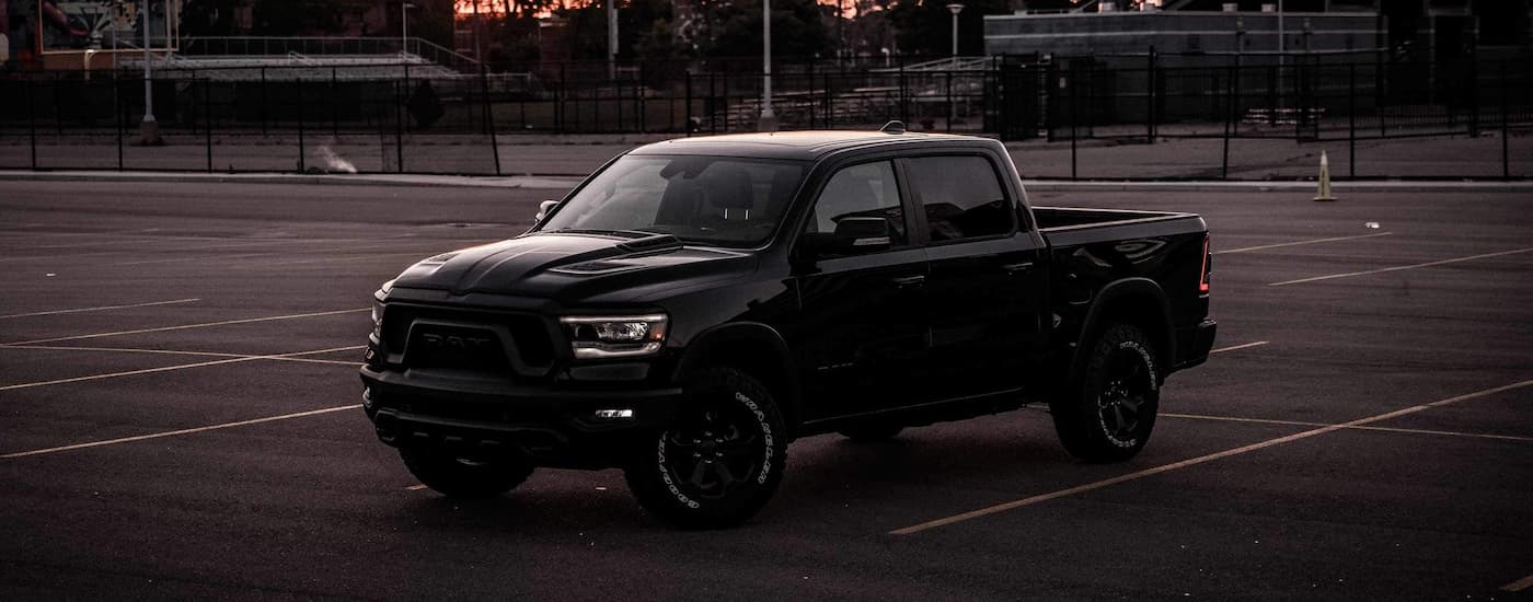 Black used 2022 Ram 1500 for sale parked in an empty lot.