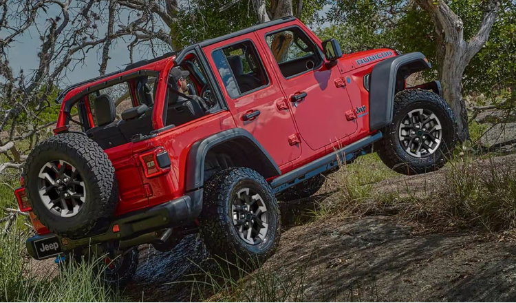 Red Jeep Wrangler up a hill