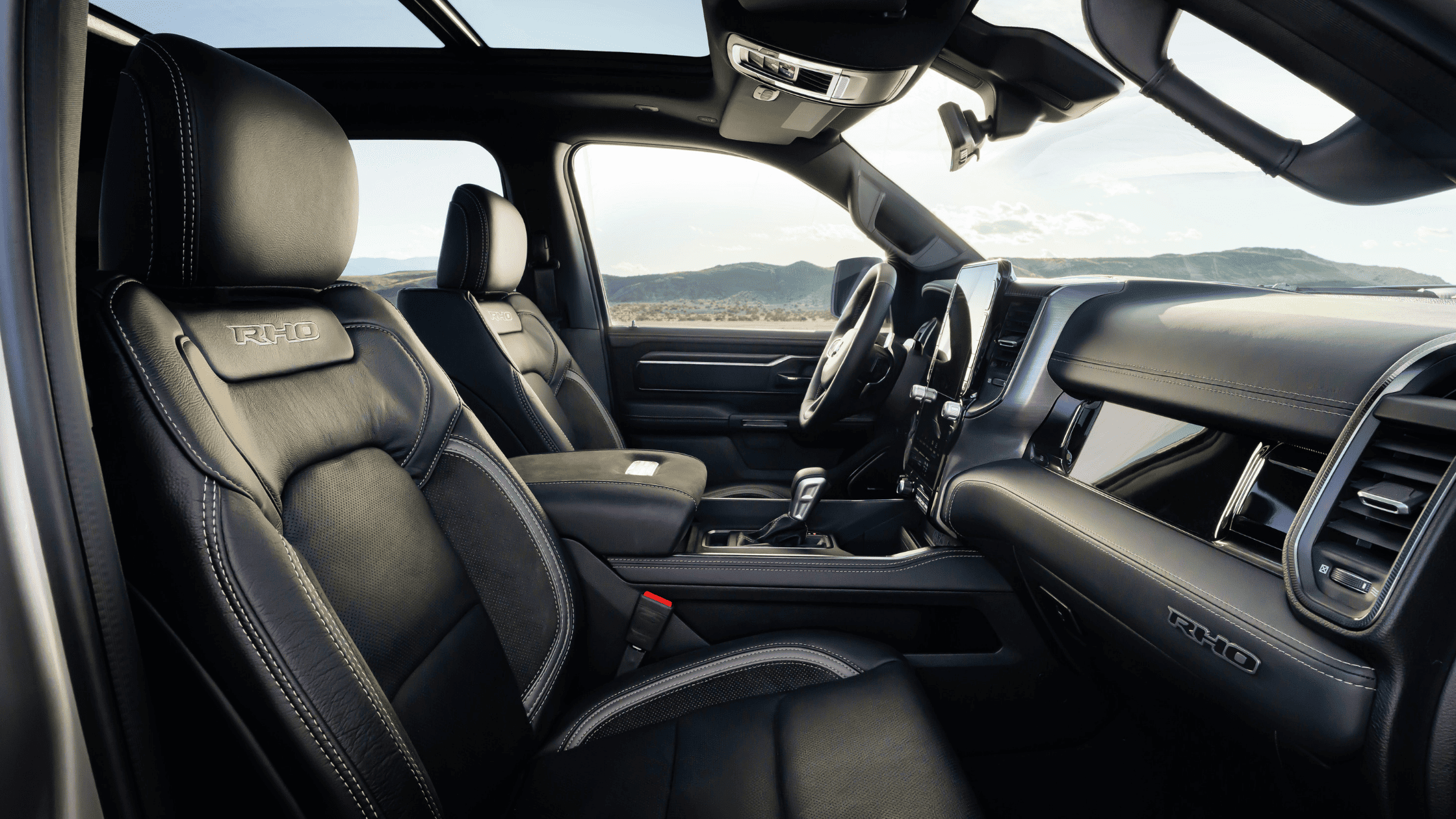 Close view of Ram 1500 RHO interior with stitched leather seats and panoramic roof.