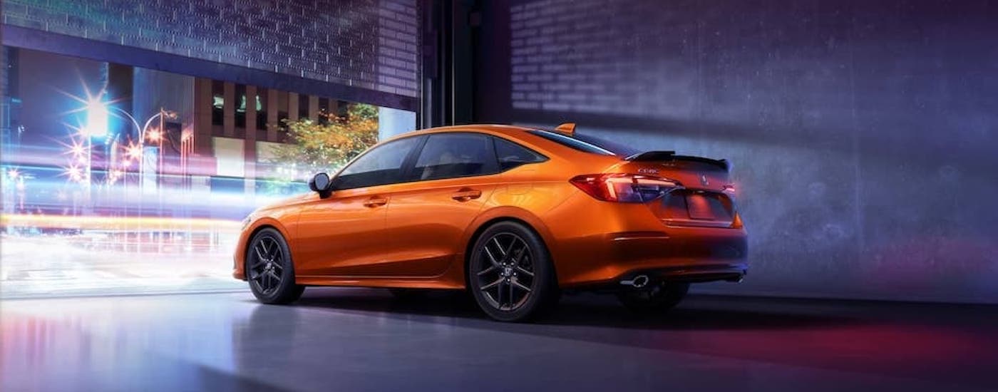 An orange 2022 Honda Civic Si from the side.