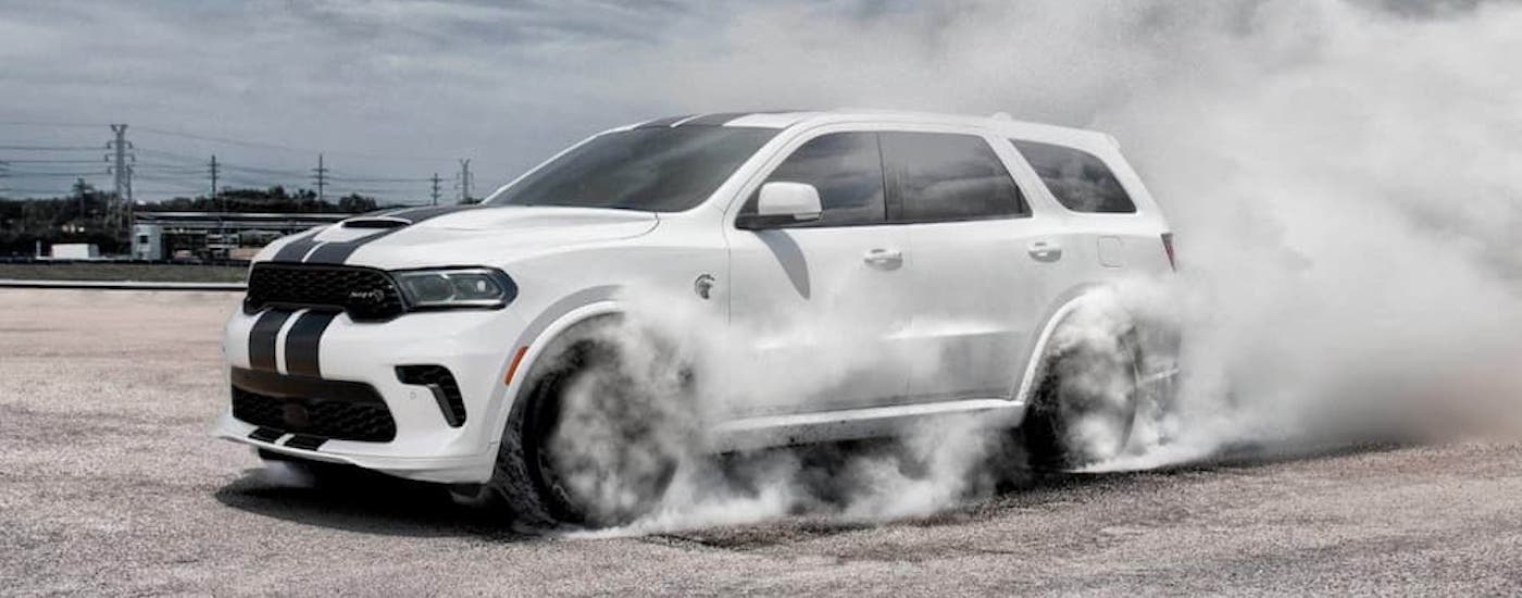A white 2023 Dodge Durango from the side after leaving a Dodge dealer near Cypress.