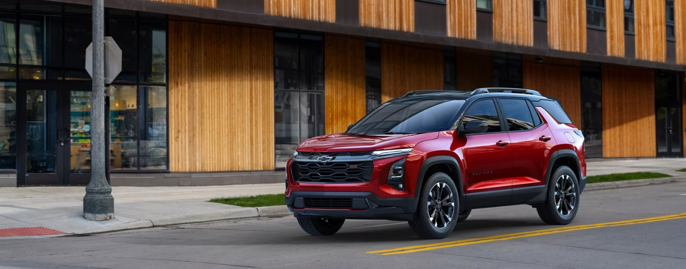 A red 2026 Chevy Equinox for sale near Lincoln from the side.