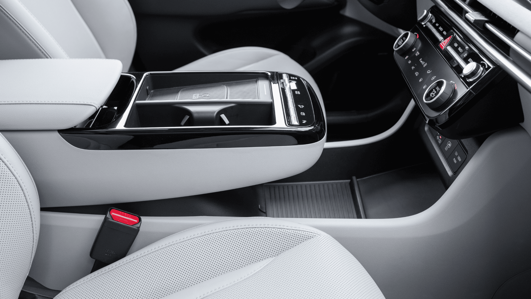 Close-up of 2025 Hyundai Tucson Hybrid center console with cupholders and electronic controls