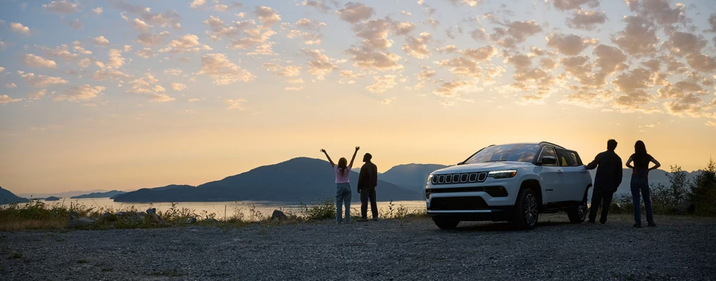 A white 2025 Jeep Compass from the front.