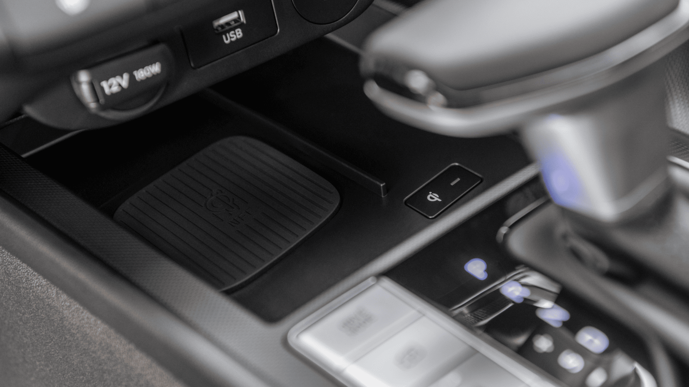 Close-up of 2025 Hyundai Elantra gear selector with Qi wireless charging pad and USB ports