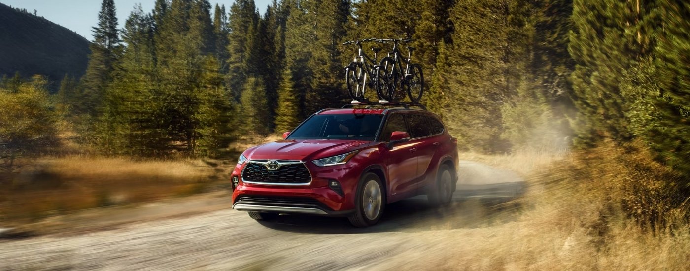 A red 2025 Toyota Highlander for sale near me from the front at an angle.