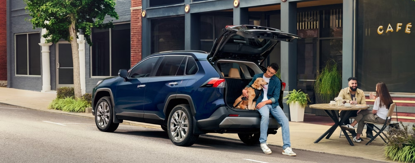 A blue 2025 Toyota RAV4 Hybrid from the side.