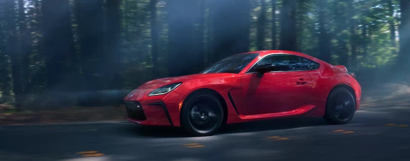 A red 2022 Toyota GR86 from the side after leaving a dealer that has a used Toyota for sale near me.