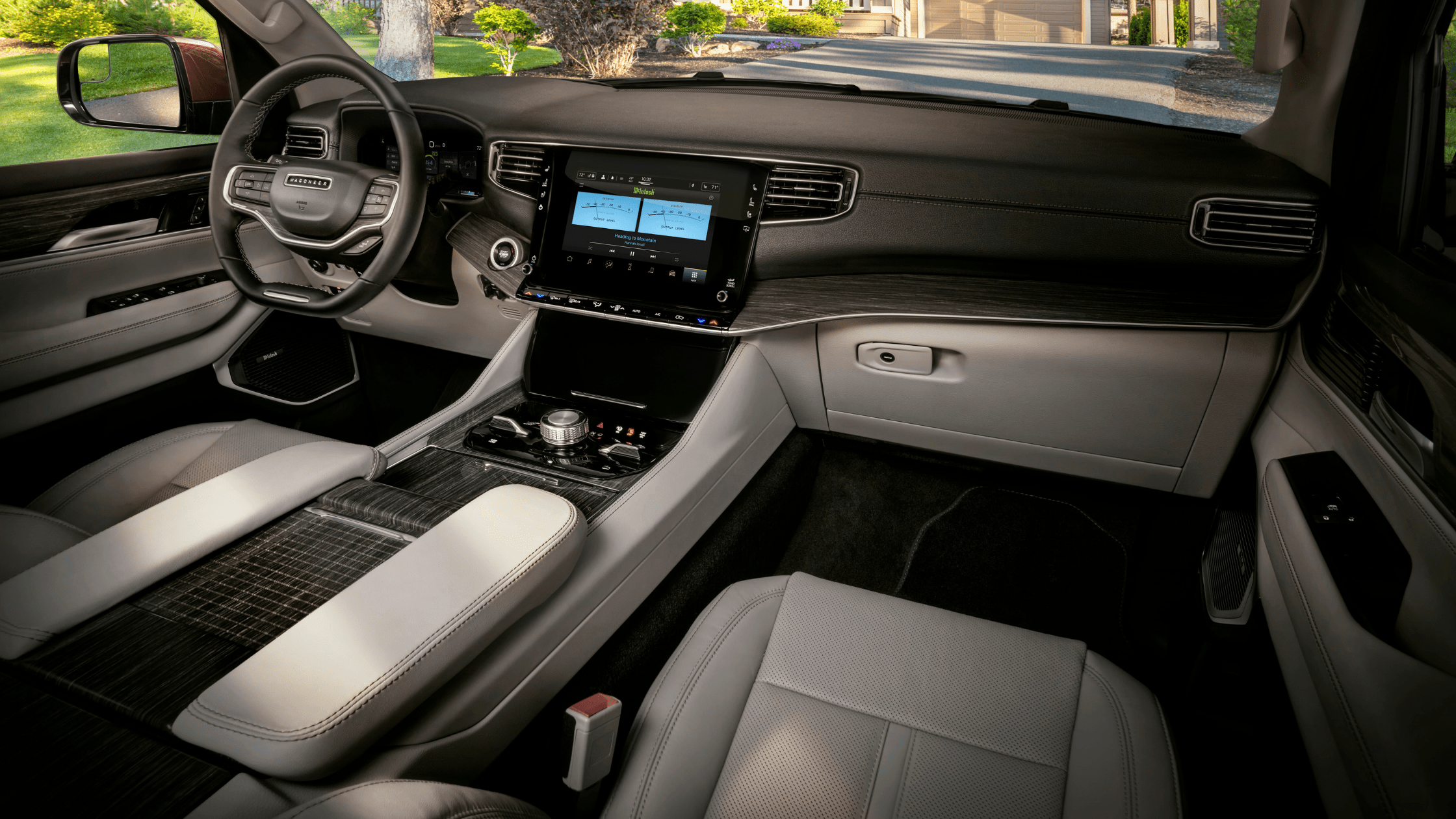 Interior view of the 2025 Jeep&reg; Wagoneer highlighting the upscale dashboard, touchscreen display, and two-tone seating.