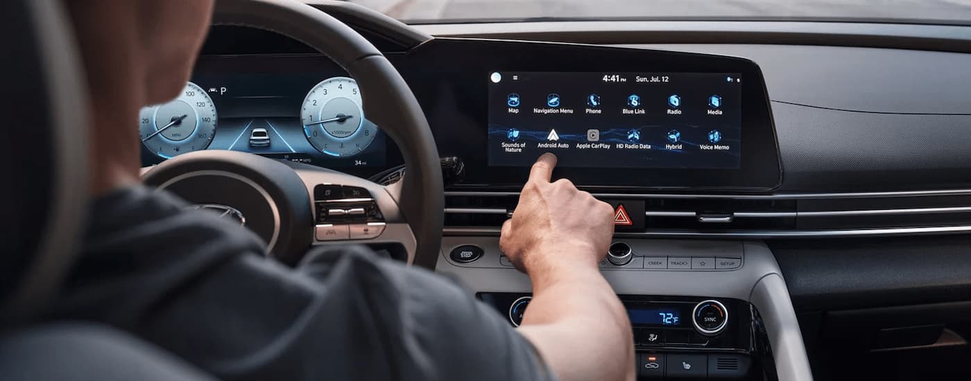 Man using infotainment screen in a 2023 Hyundai Elantra.