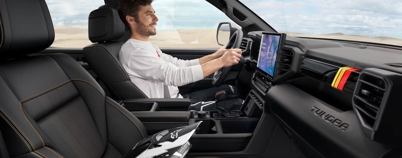 Man driving in a 2025 Toyota Tundra for sale near Braunfels.
