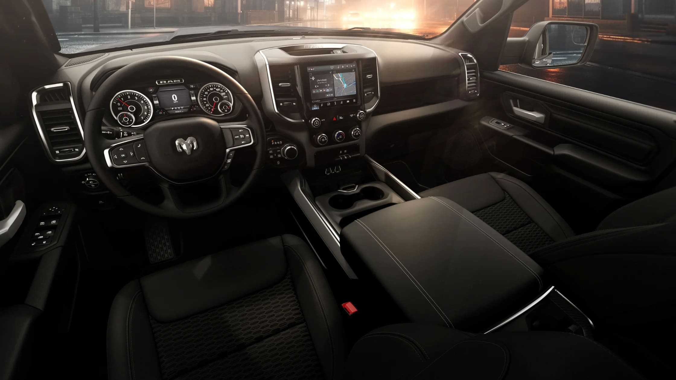 Black interior of the 2026 Ram 1500 Express featuring touchscreen navigation and multifunction steering.