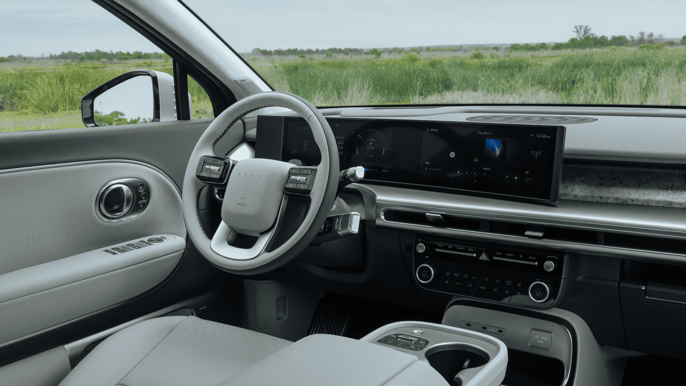 Steering wheel and widescreen display of 2026 Hyundai IONIQ 9 viewed from driver's side.