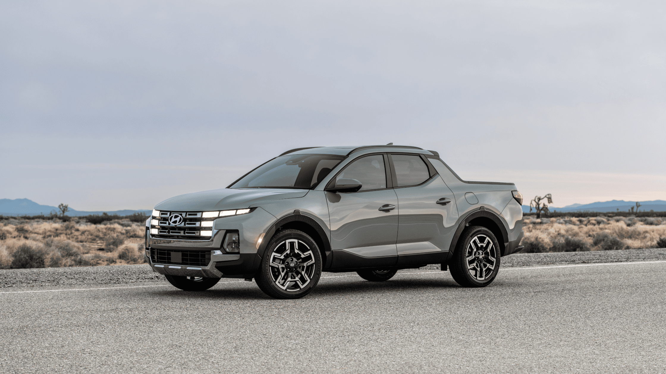 Side profile of the 2025 Hyundai Santa Cruz pickup in desert setting with modern LED headlights.