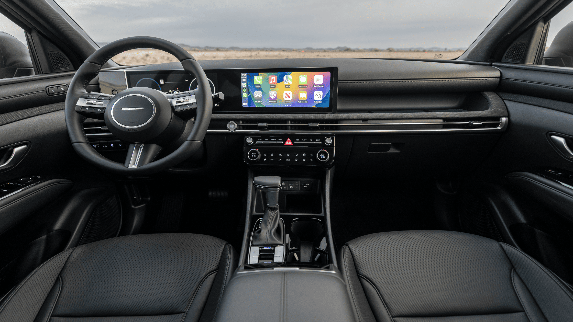 2025 Hyundai Santa Cruz interior with black leather seats and widescreen infotainment display.