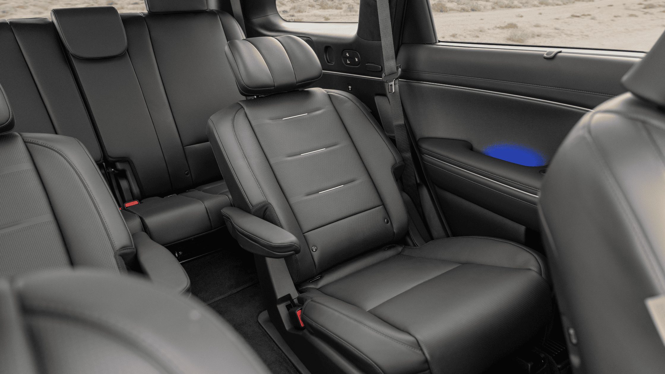 Captains chairs and third-row seating inside the 2026 Palisade with ambient lighting.