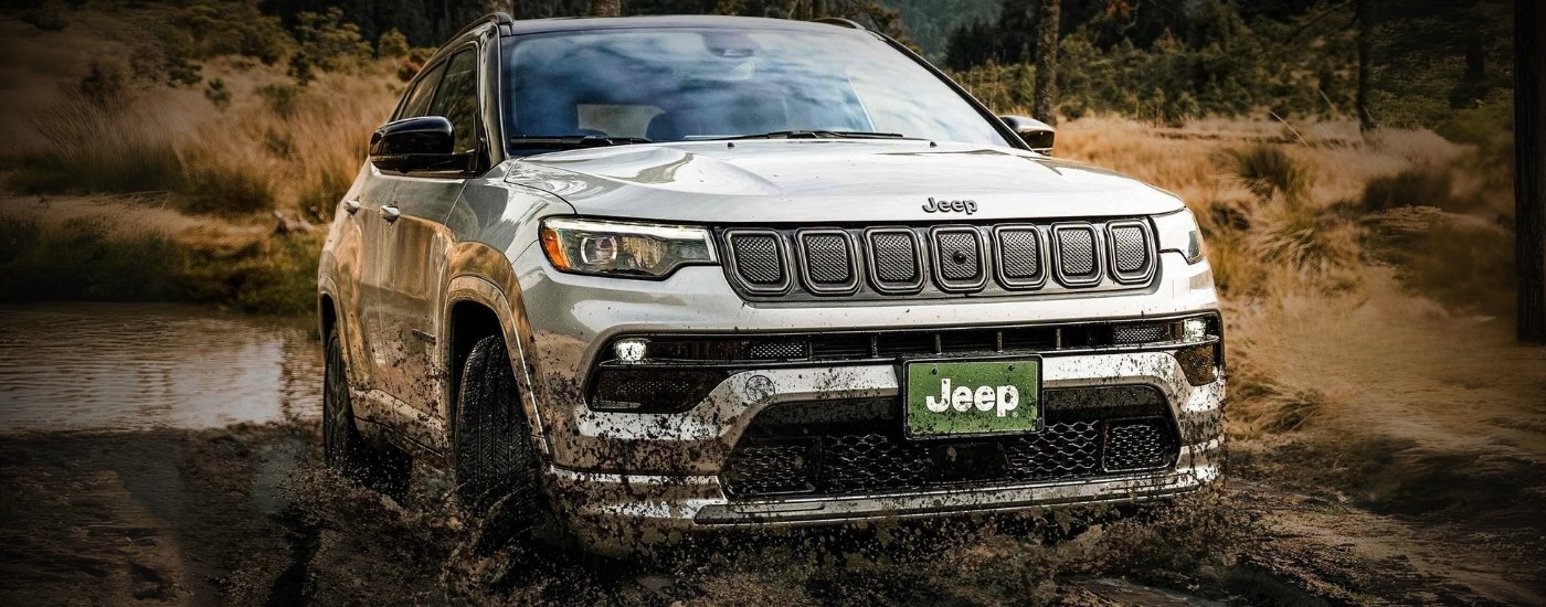 A silver 2025 Jeep Compass for sale in Houston off-roading.