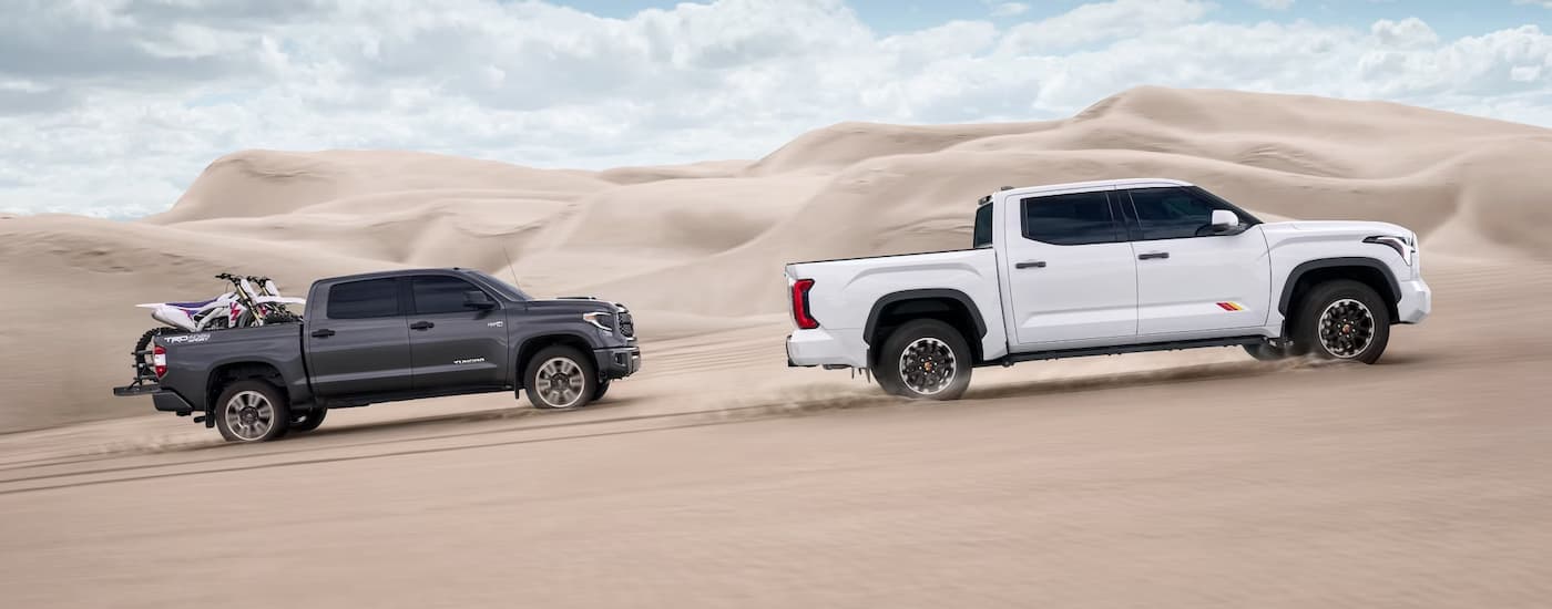 White and grey 2025 Toyota Tundra off-roading on sand.