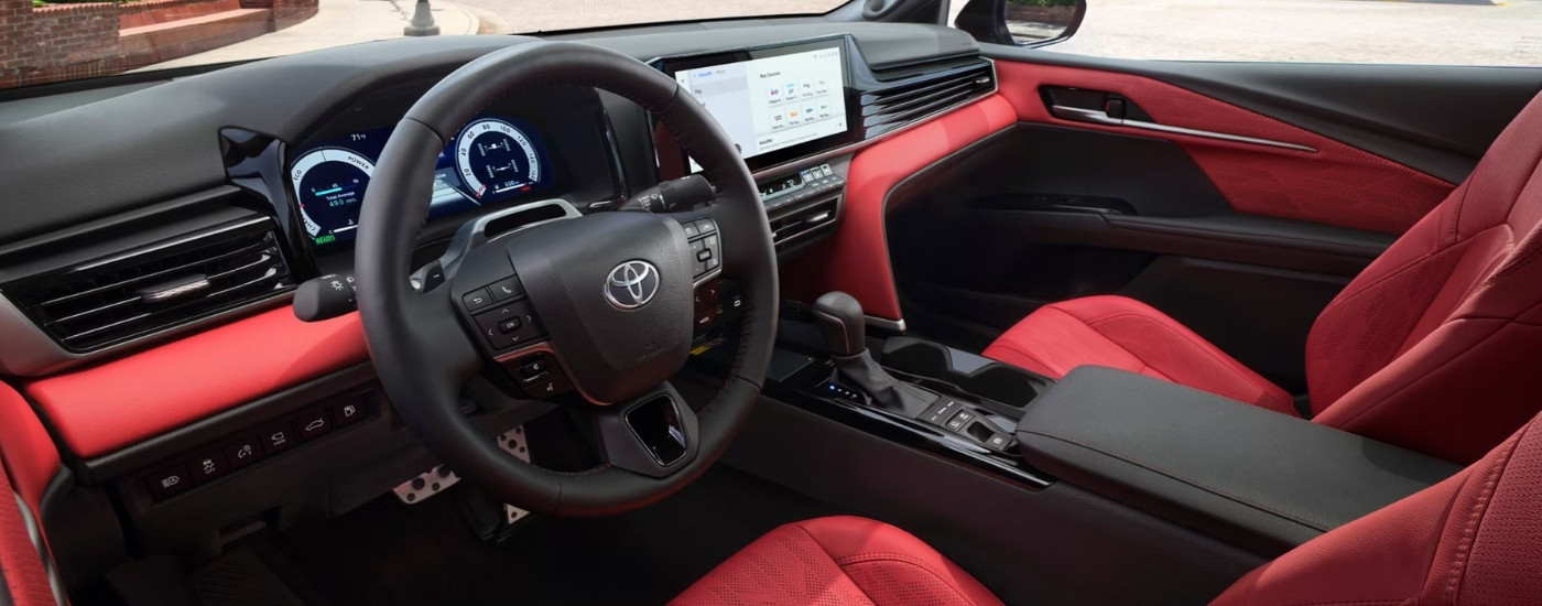 The red interior of a 2025 Toyota Camry.