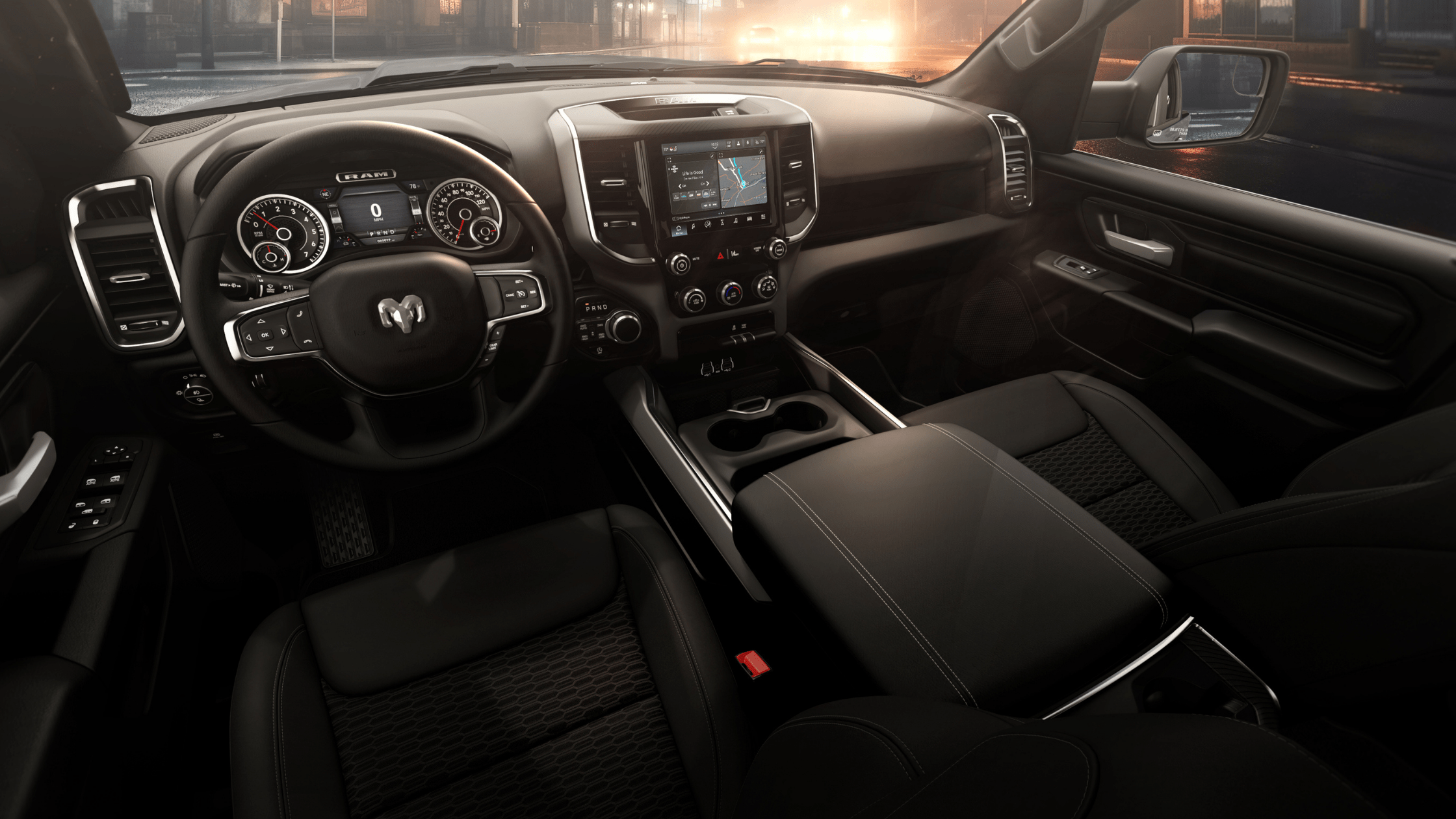Black interior of the 2026 Ram 1500 Express featuring a digital cluster and Uconnect touchscreen.